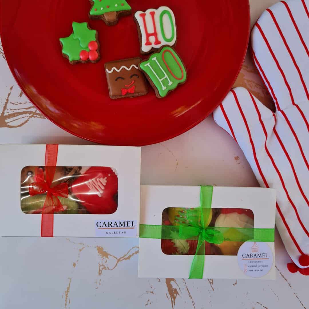 Bandeja con galletas navideñas decoradas con glaseado y letras que dicen "HO HO".