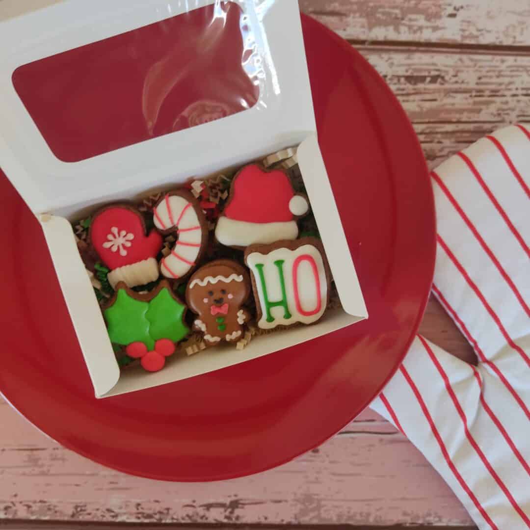 Árbol de galletas navideñas en caja, decoradas con motivos festivos y colores tradicionales.